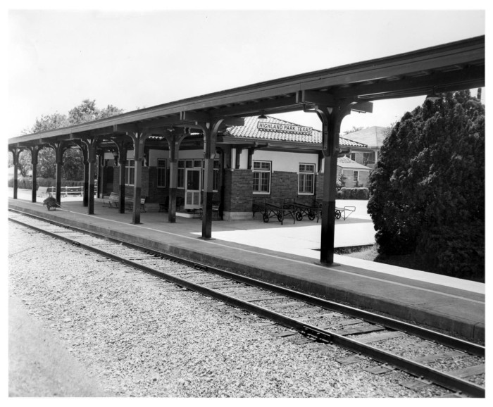 Black-and-white photograph of the Highland Park Katy depot, with its platform canopy beside the railway tracks.